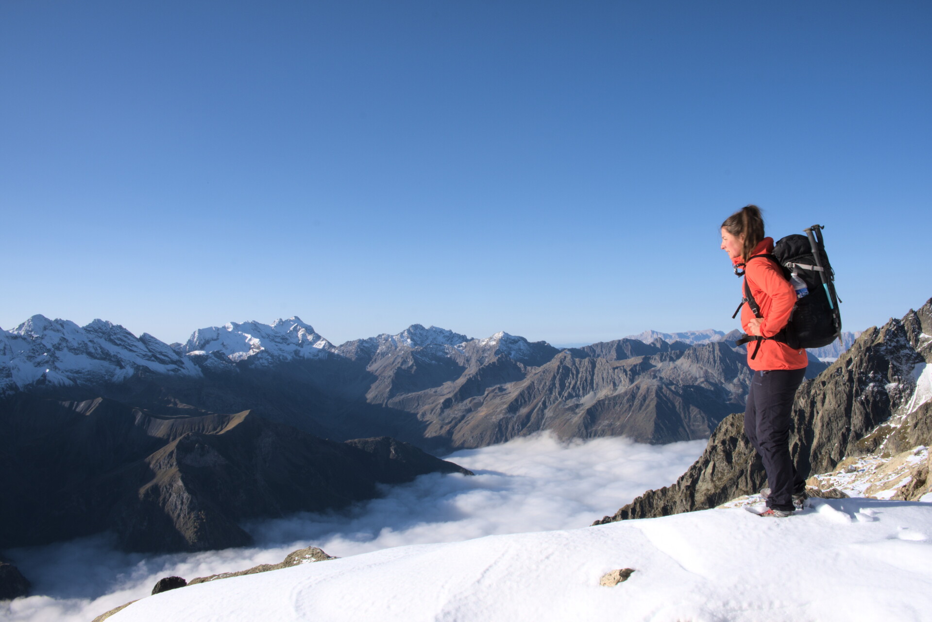 Walker on a ridge above a sea of cloud, Valgaudemar