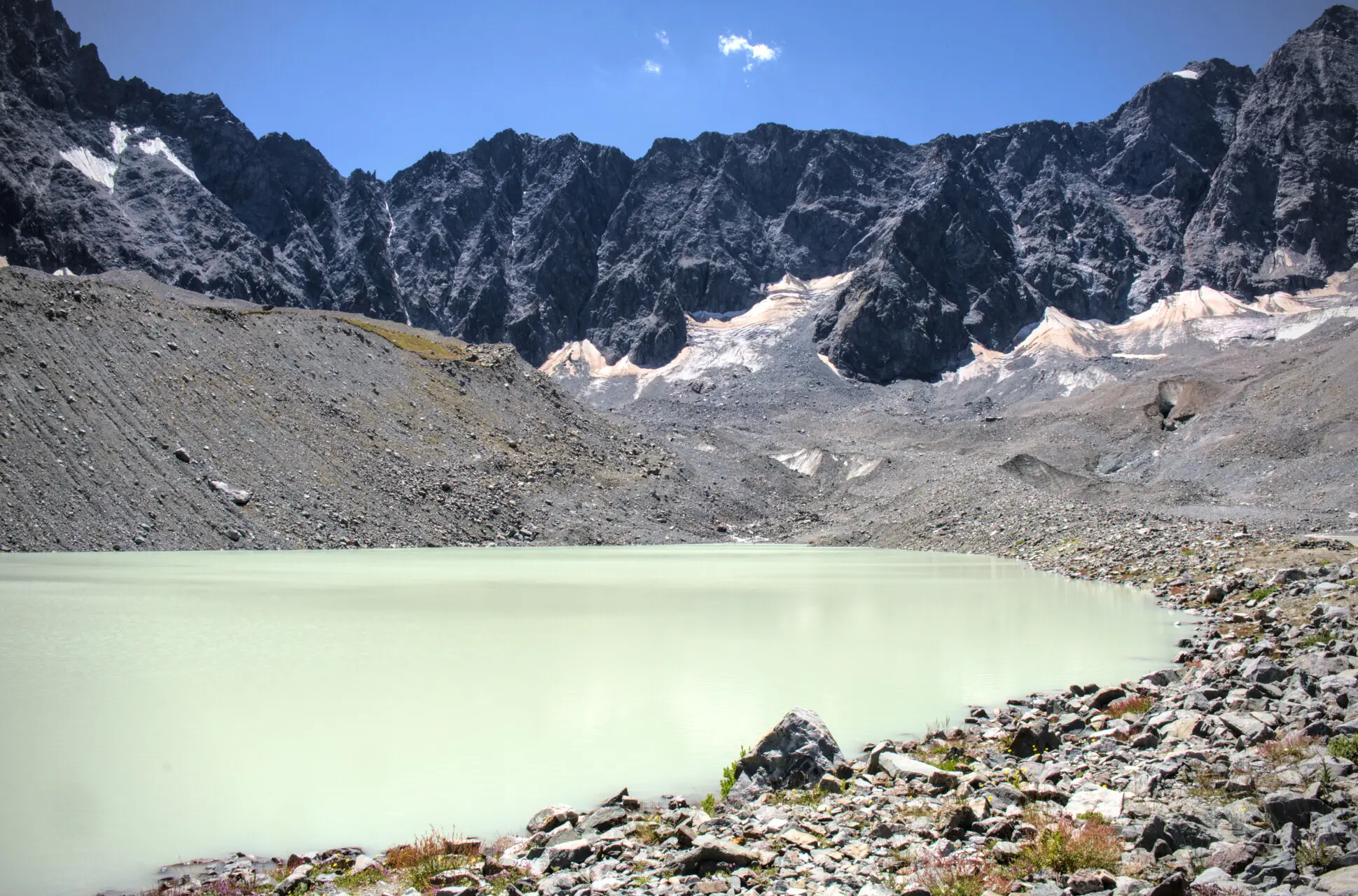 Lac du Glacier d'Arsine and its milky waters, enclosed by moraines and rock walls
